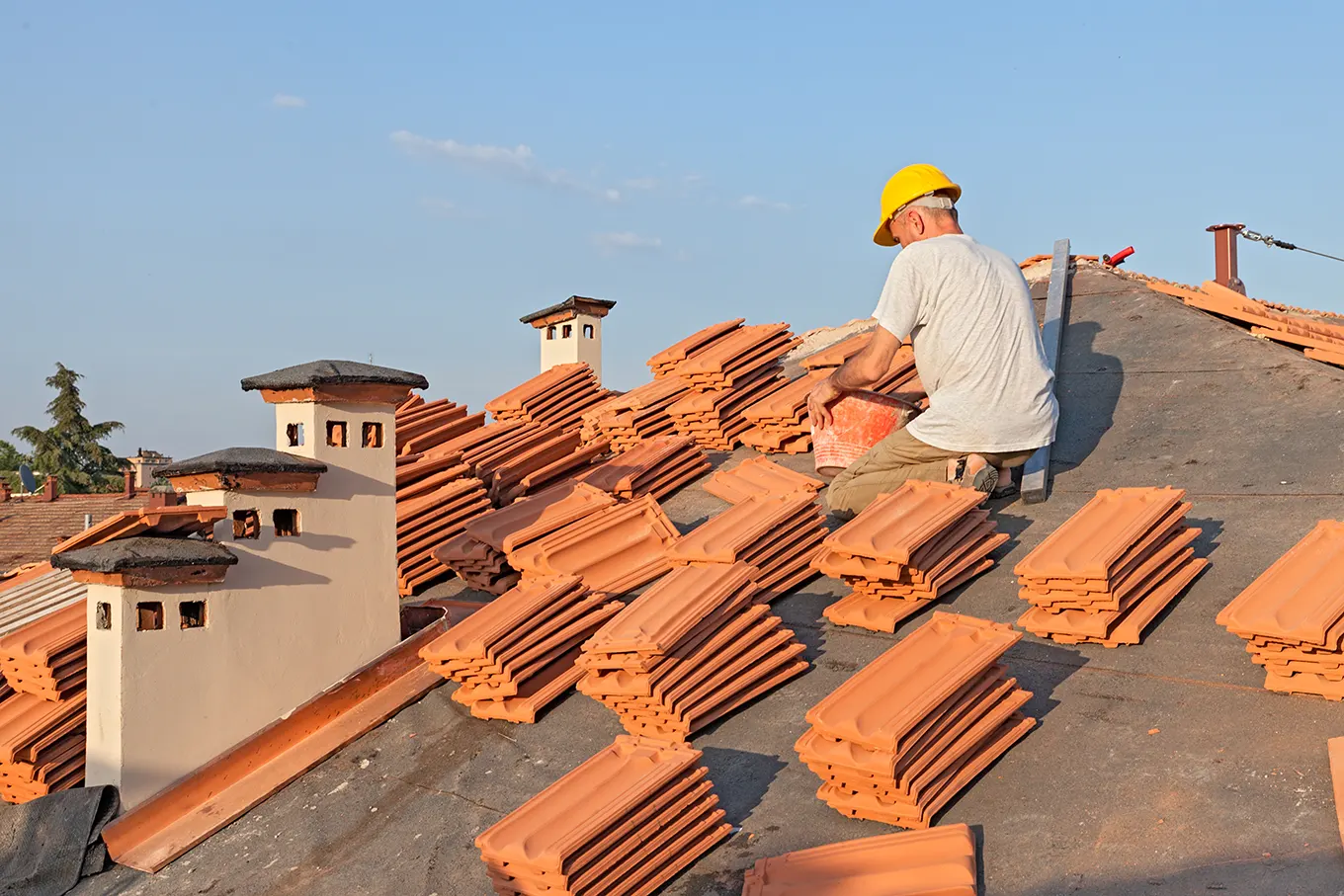 Roof tiles being laid on a pitched roof
