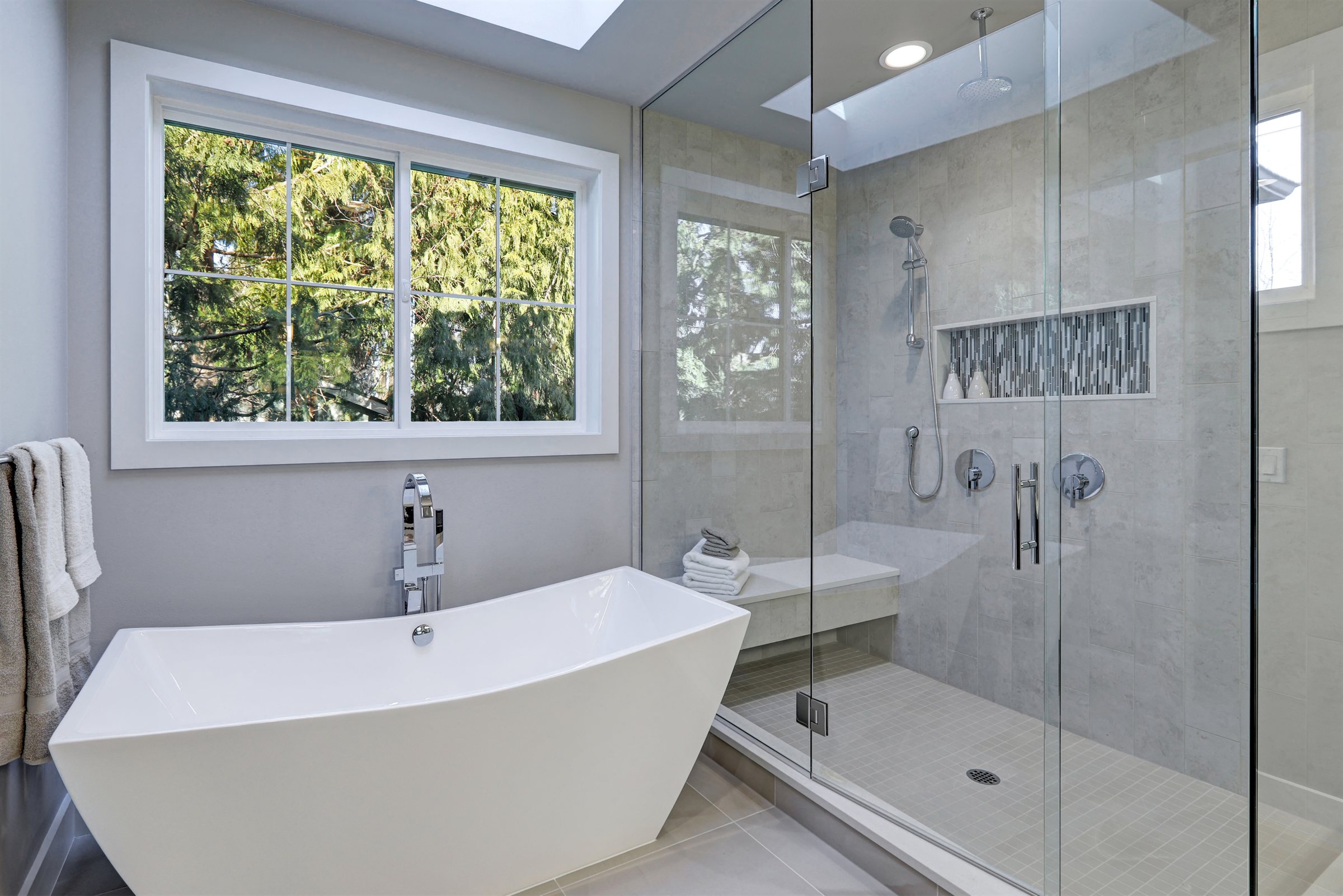 Master bathroom remodel with a freestanding tub and a frameless glass shower