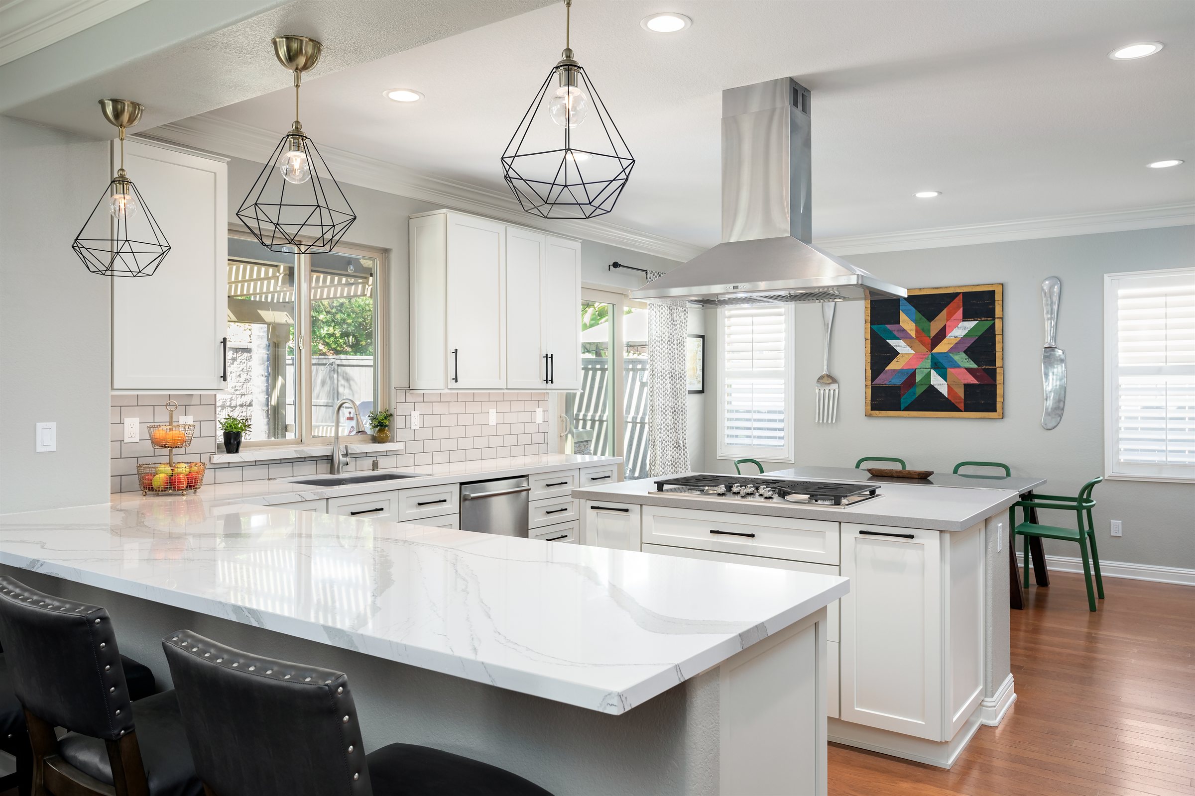White shaker kitchen remodel with a quartz island and pendant lighting