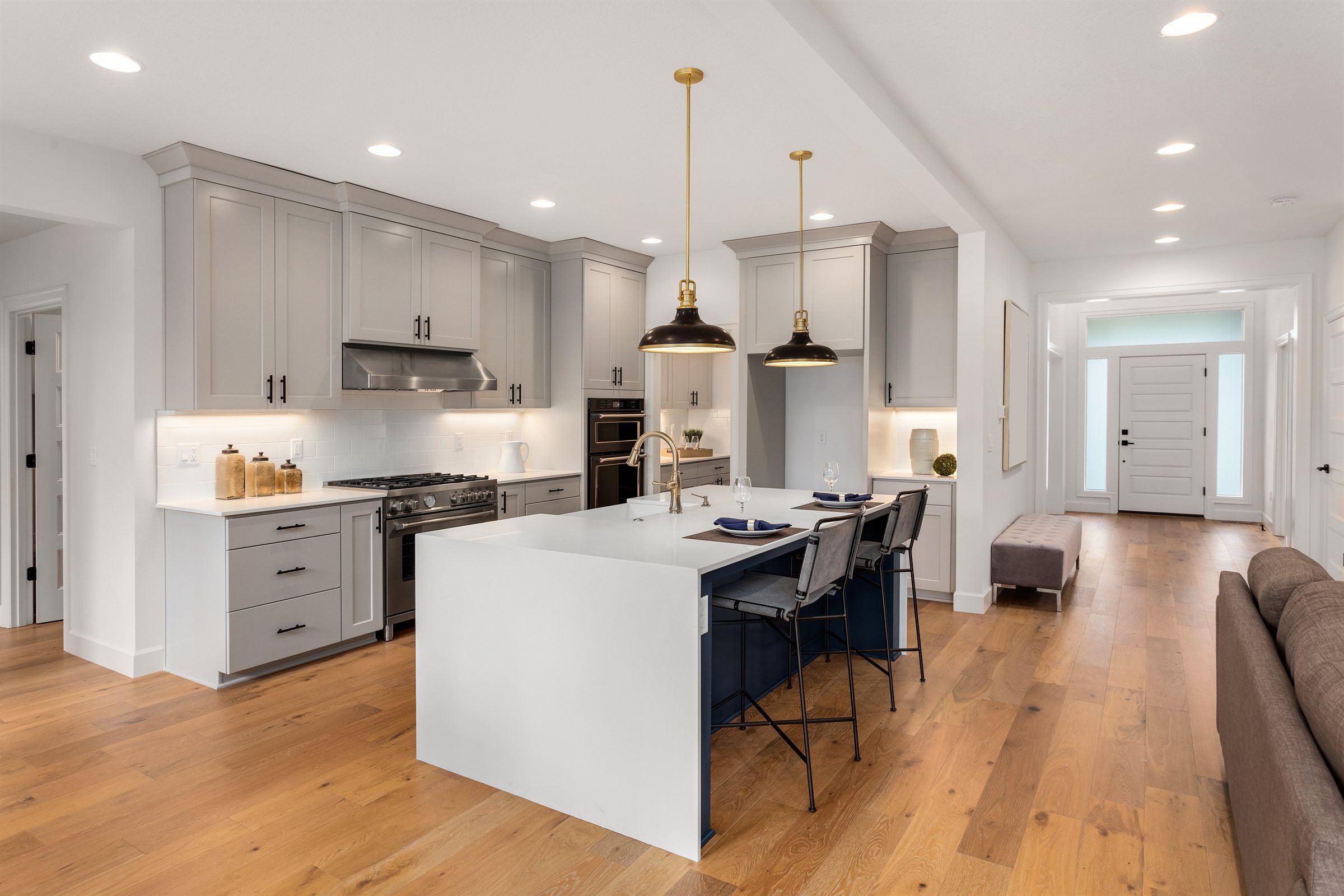Grey shaker kitchen remodel with a waterfall quartz island