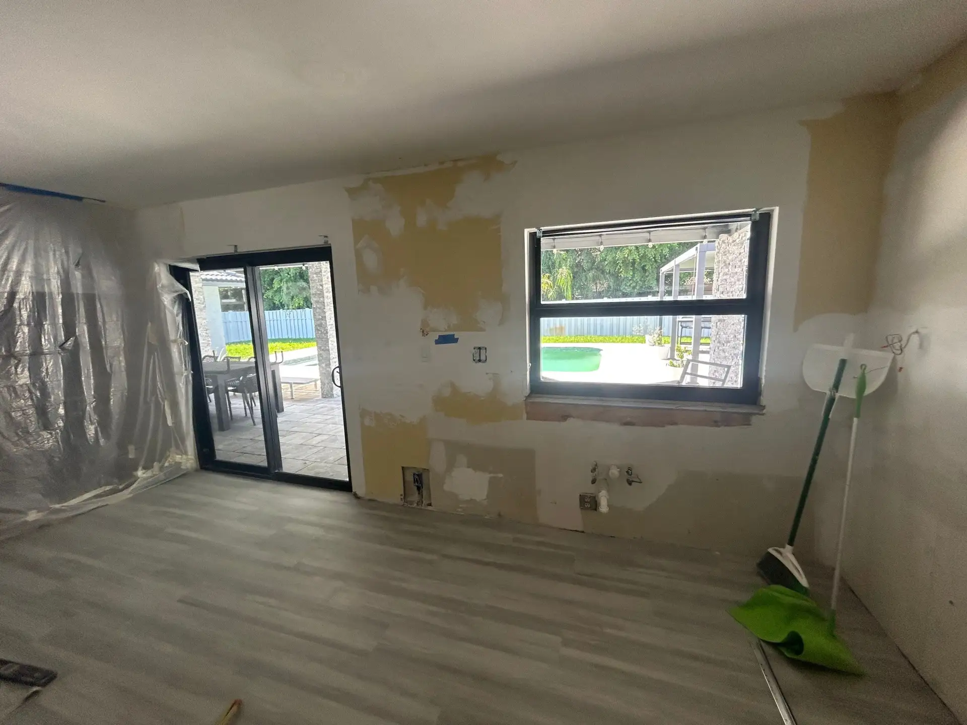 Room stripped back to bare walls and plastic sheeting during a kitchen remodel in Coral Springs, FL 33071